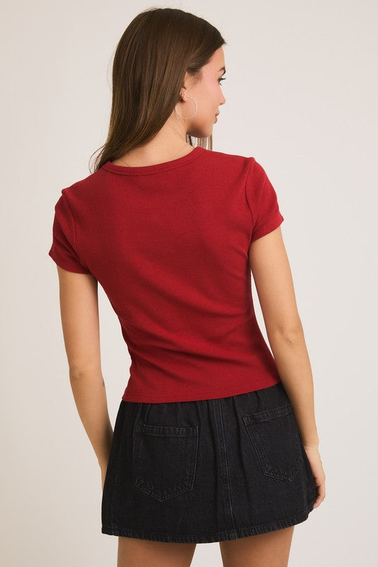 Woman in red shirt and black skirt.