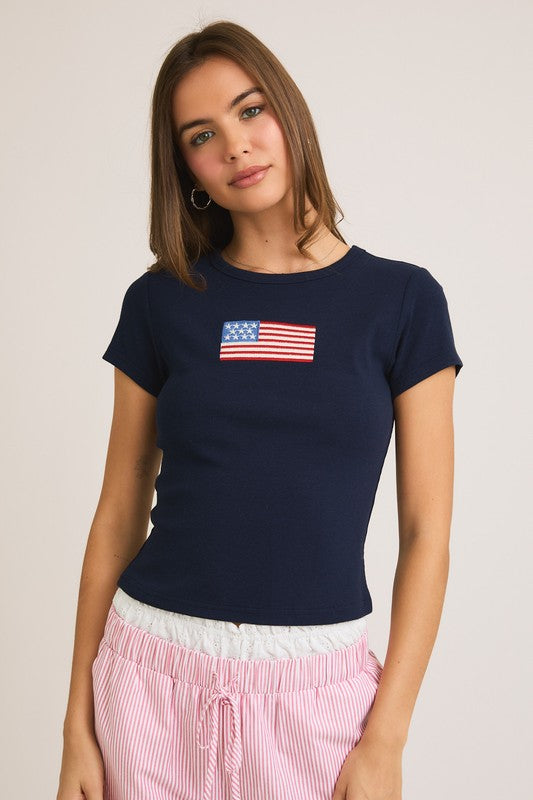 Woman wearing a navy t-shirt with an American flag.