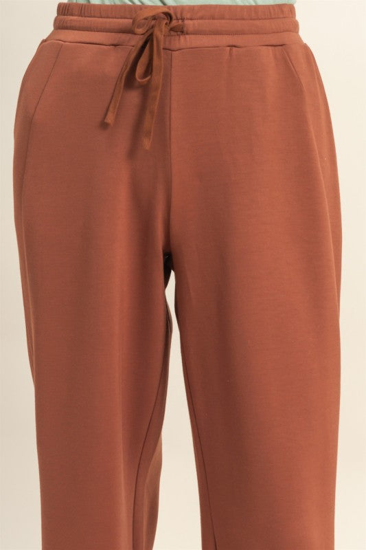 Brown pants with a drawstring on a beige background