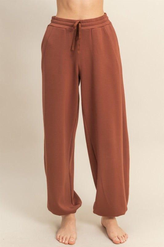 Brown sweatpants on a beige background