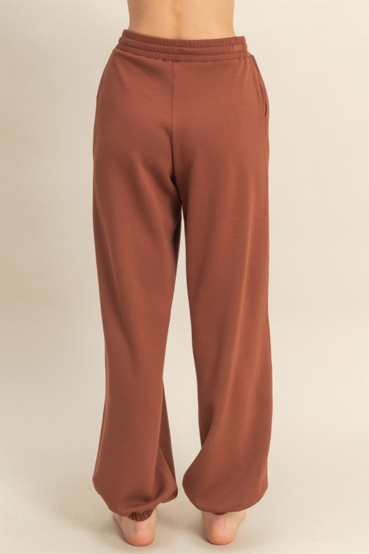 Brown sweatpants on a beige background