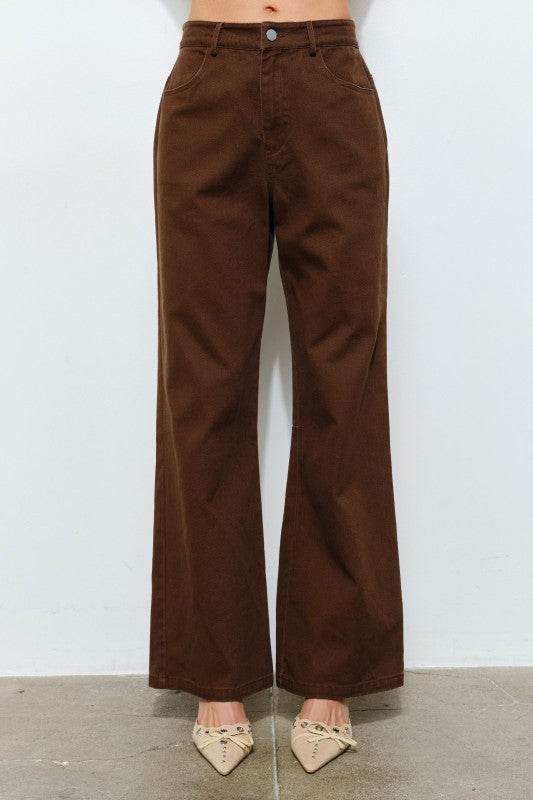 Brown wide-leg pants worn by a person on a white background