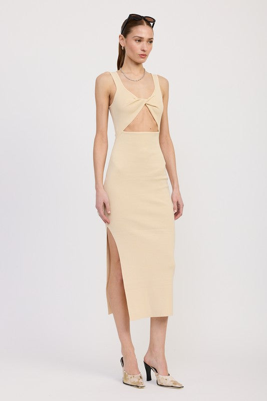 Woman wearing a light yellow dress with cut-out design on a white background
