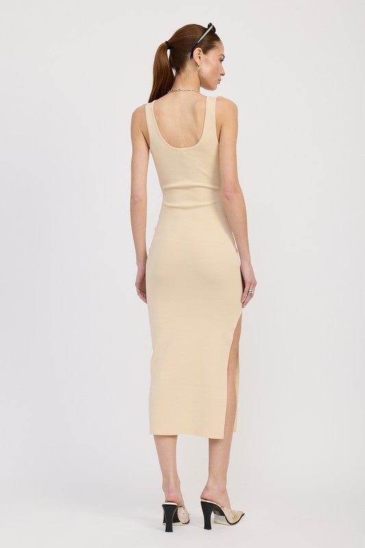 Woman wearing a beige sleeveless dress with a slit on a white background