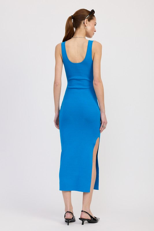 Woman wearing a blue dress with a slit on a white background