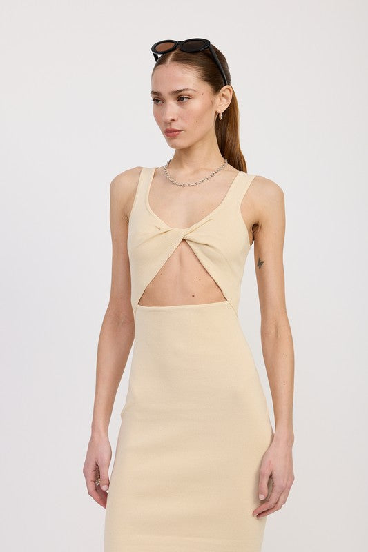 Woman wearing a beige dress with a cutout design on a white background