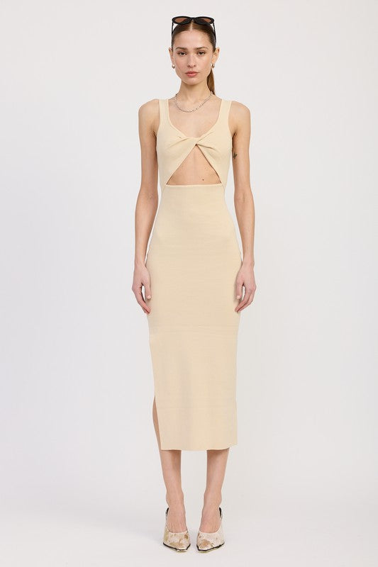 Woman wearing a beige dress with cut-out design on a white background