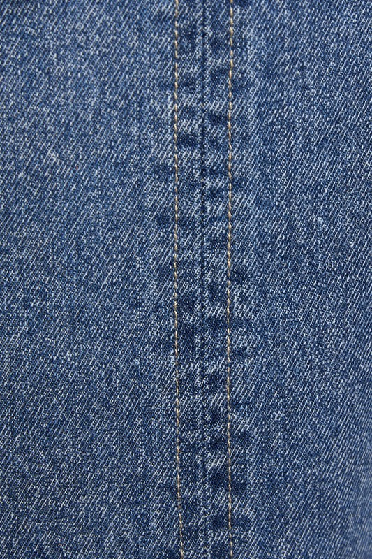 Close-up of blue denim fabric with a visible stitch