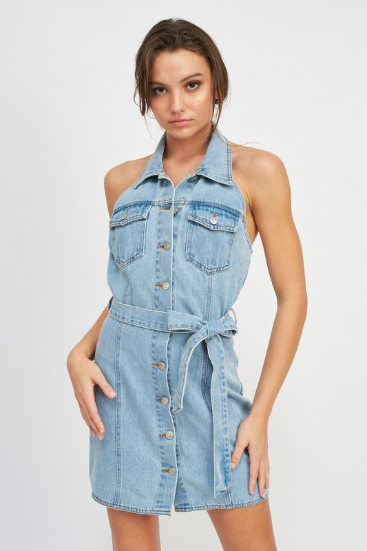 Woman wearing a denim dress on a white background