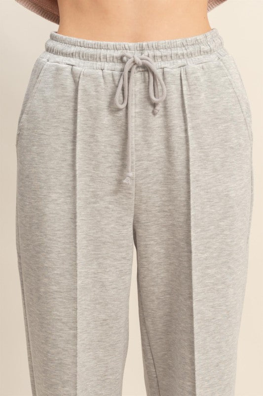 Gray sweatpants with a drawstring on a beige background