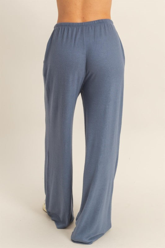Blue lounge pants on a beige background