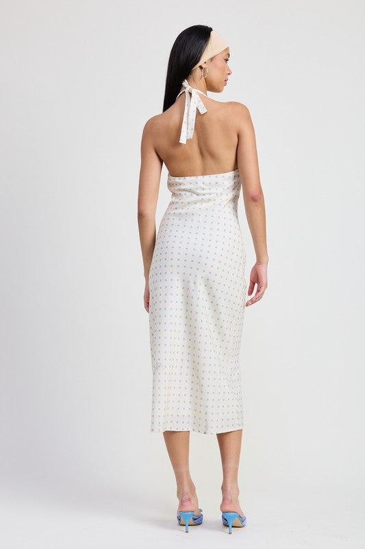 Woman wearing a white dress with a subtle pattern on a plain background