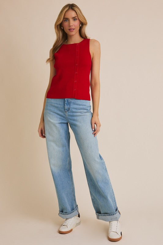 Woman in red top and blue jeans.