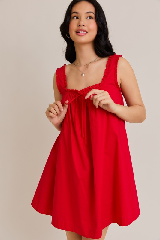Woman wearing a red dress against a plain background