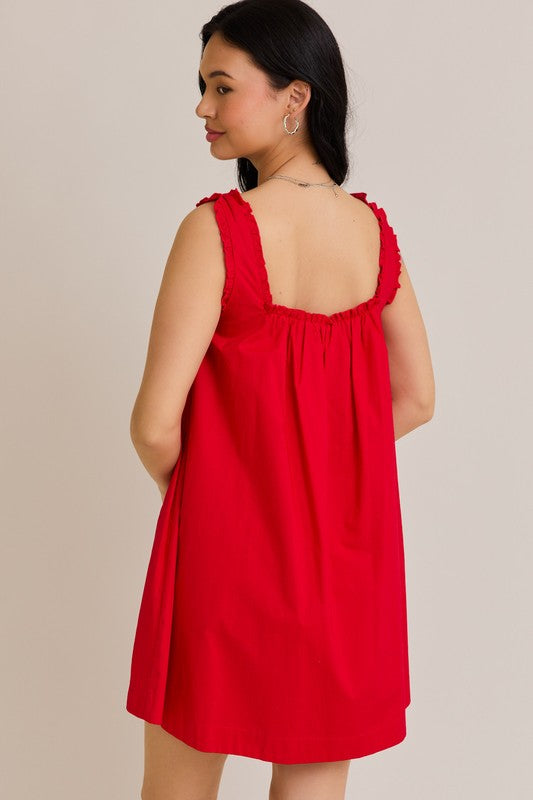 Woman wearing a red dress with a plain background