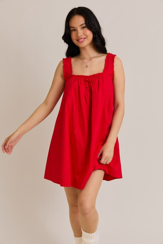 Woman wearing a red dress against a plain background