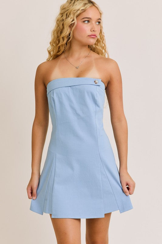 Blonde woman wearing a light blue strapless dress.