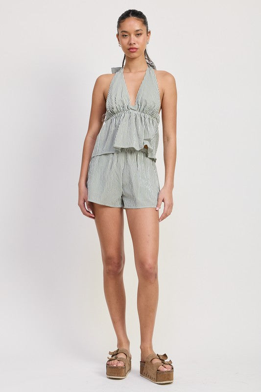 Woman wearing a striped romper on a white background
