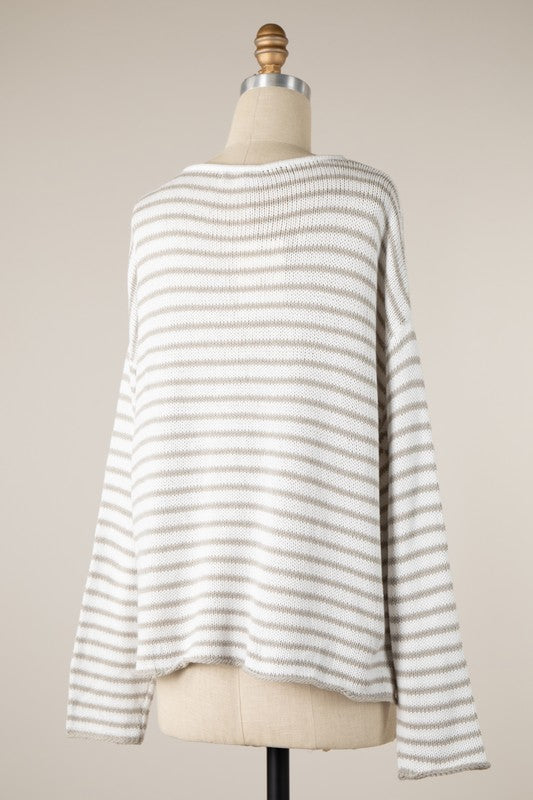 Striped sweater on a mannequin against a plain background