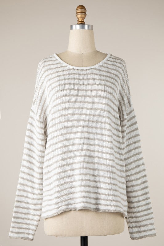 Striped sweater on a mannequin against a plain background