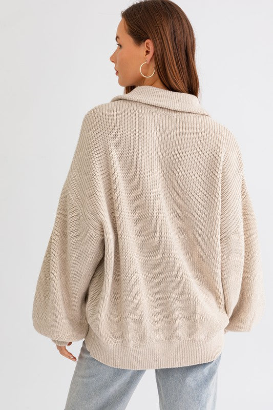 Woman wearing a beige textured sweater on a white background