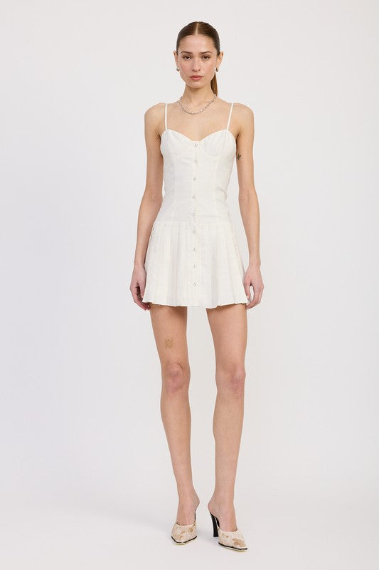 Woman wearing a white slip dress on a plain background