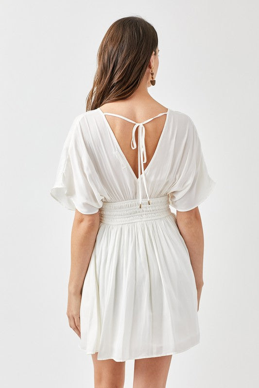 White dress with open back on a white background