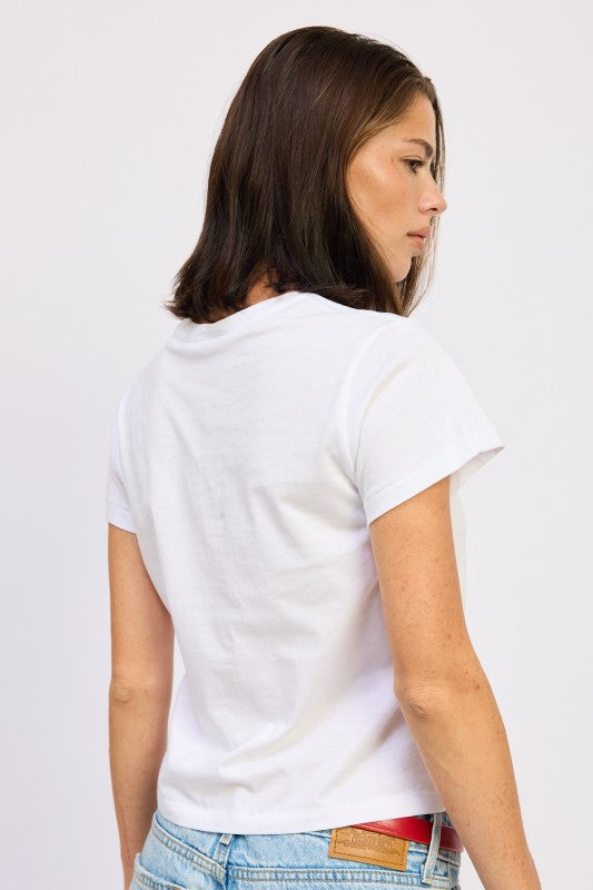 Woman wearing a white t-shirt with a visible brand logo on a plain background