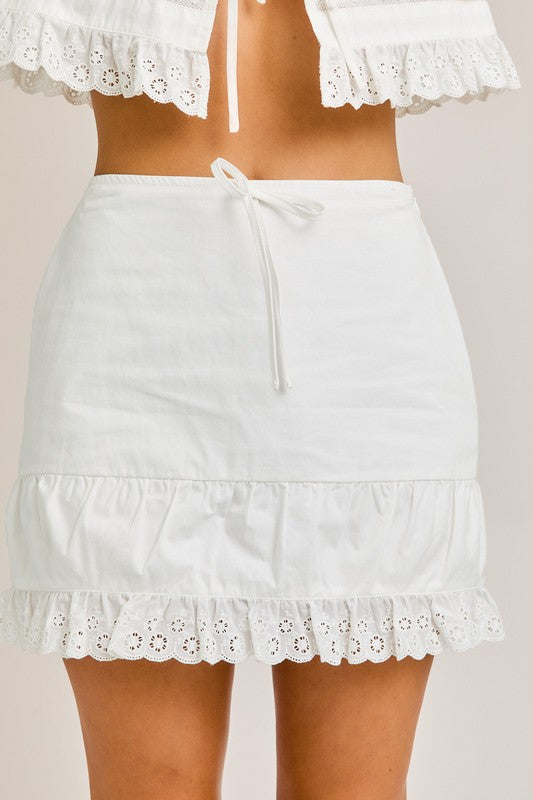White eyelet trim skirt with a drawstring waist.