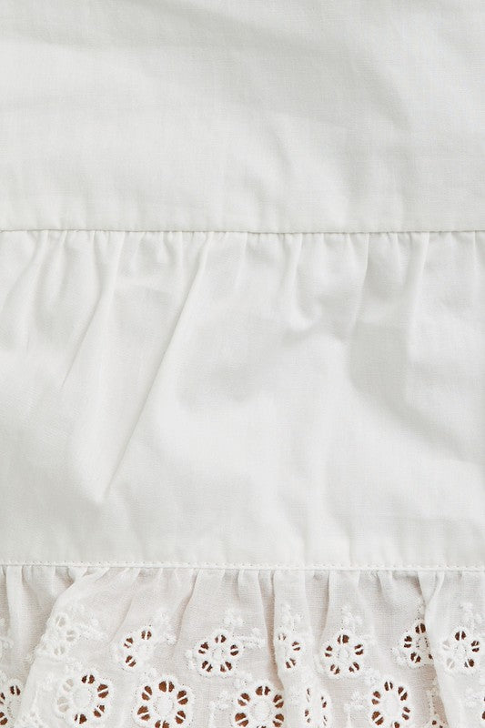 White fabric with eyelet lace trim.