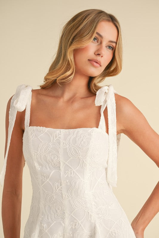 Woman in white embroidered dress.