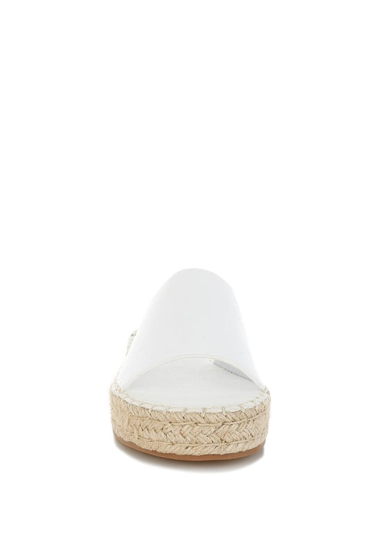 White sandal with a woven sole on a white background
