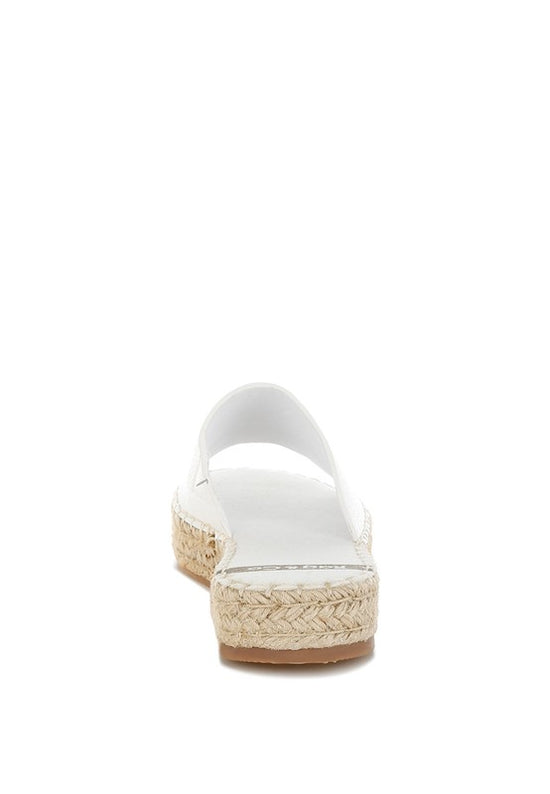 White sandal with a woven sole on a white background