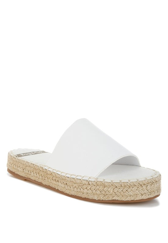 White sandal with jute sole on a white background